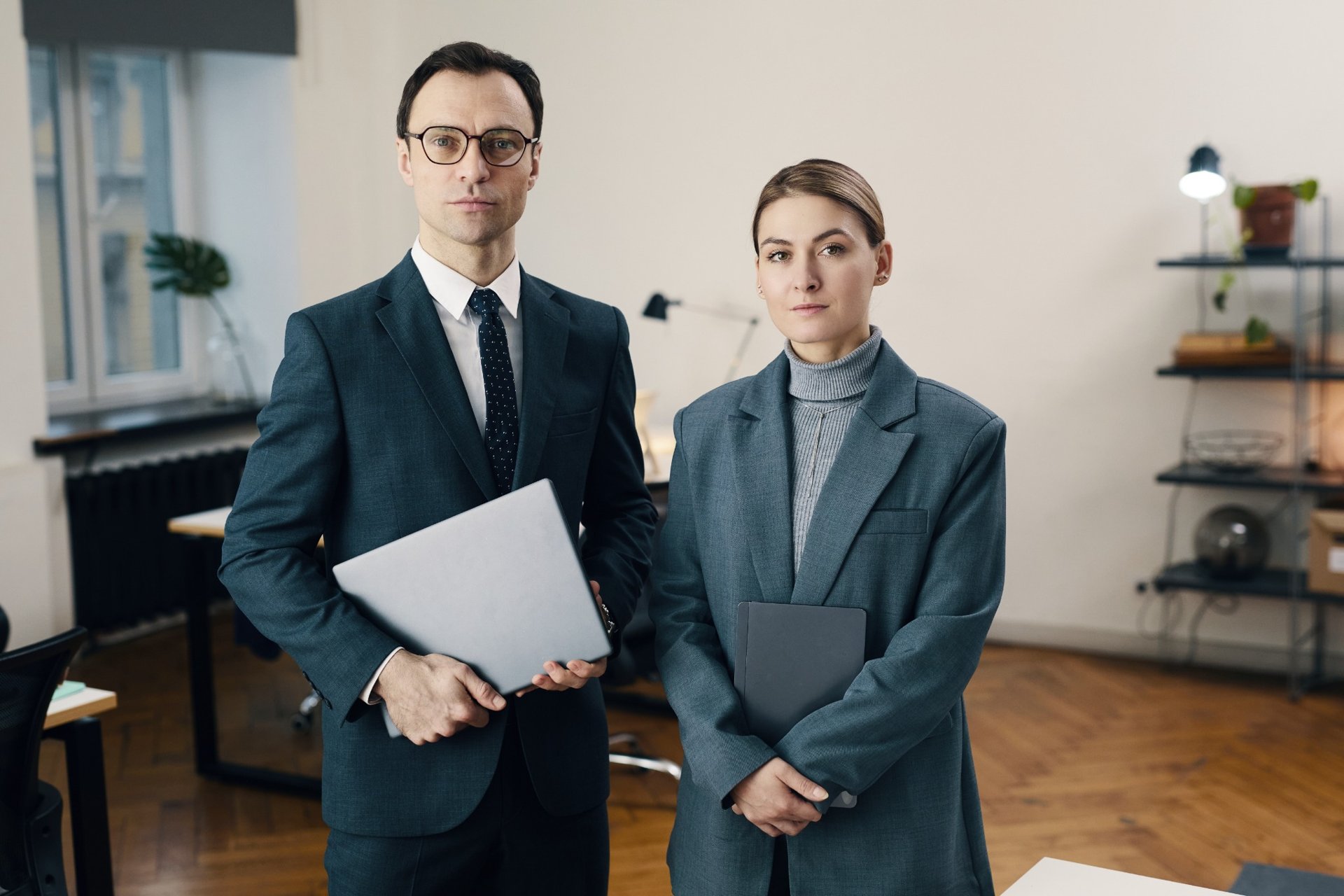 Law partners in formal attire standing in a law office