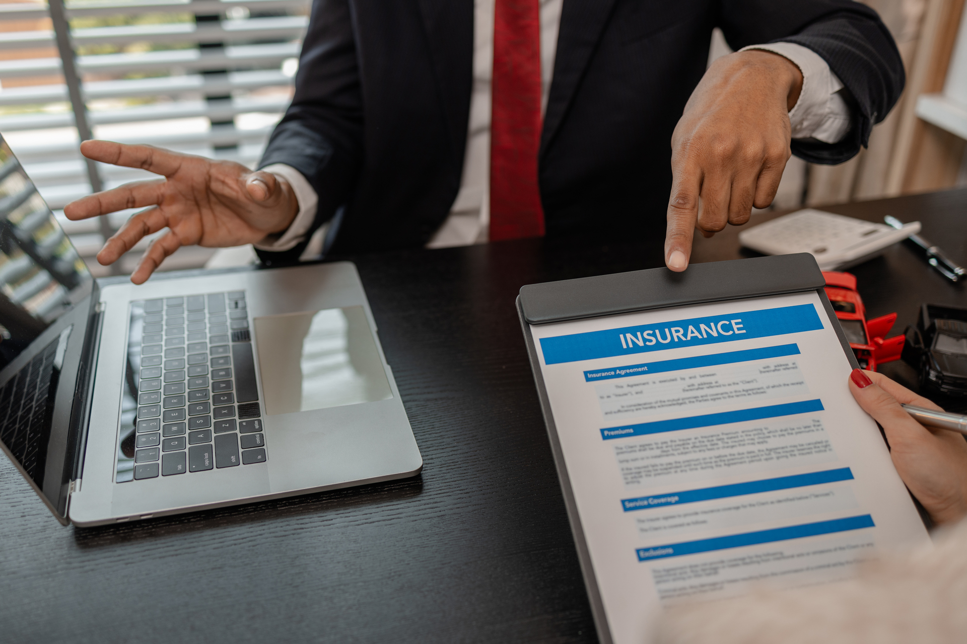Lawyer explains the details of a car insurance policy and all the costs to a client